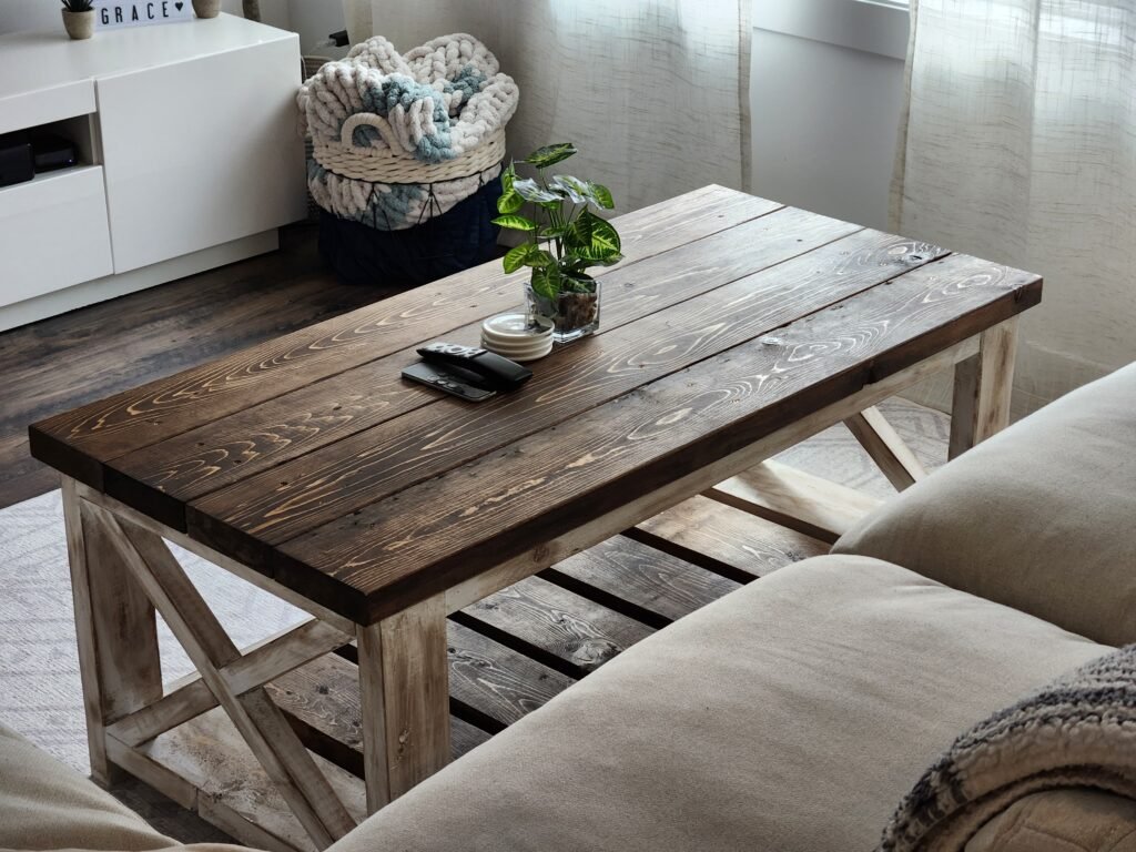 Farmstyle coffee table with beige couch and plant on top