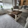 Farmstyle coffee table with beige couch and plant on top